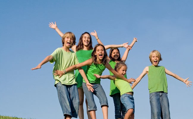happy group of kids at summer camp singing or shouting,